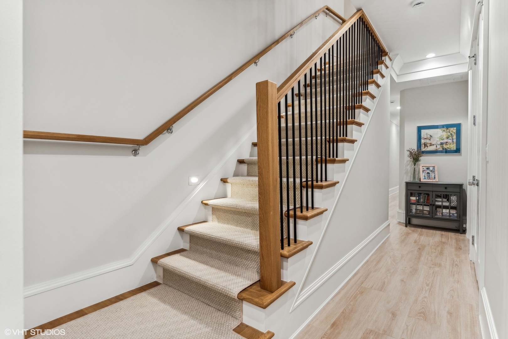 2034 North Mohawk Street, Unit 1 Chicago, IL 60614 - Photo 12 of 26 a view of staircase with wooden floor and a rug