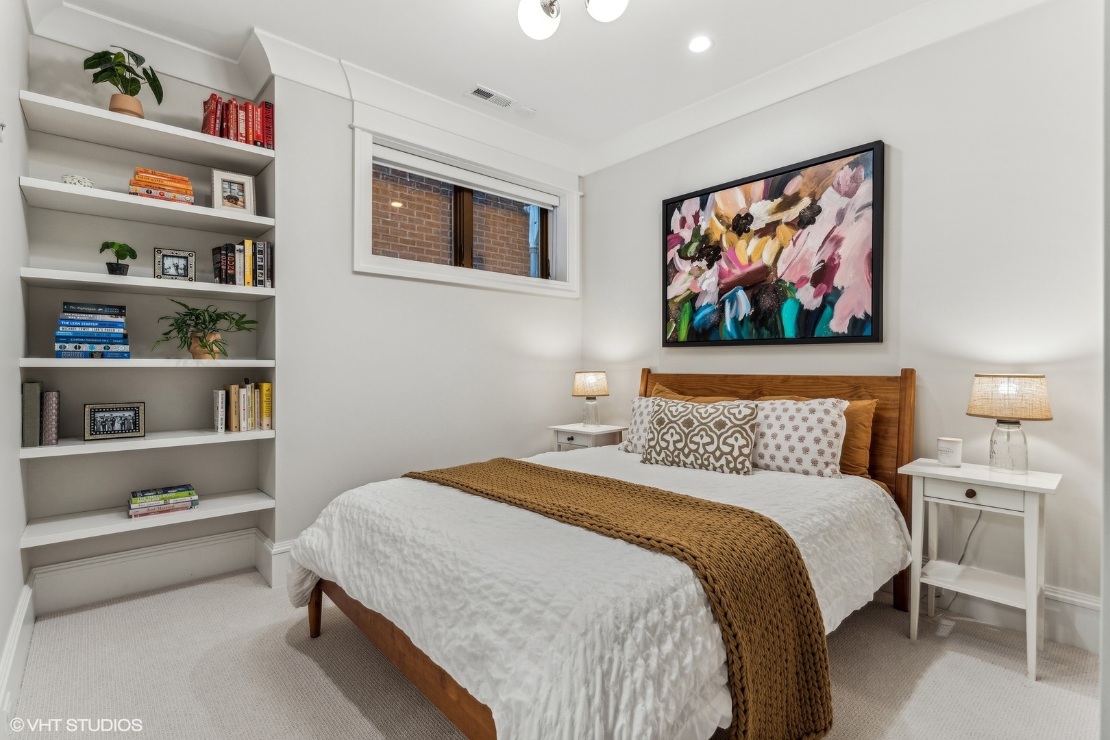 2034 North Mohawk Street, Unit 1 Chicago, IL 60614 - Photo 17 of 26 a bedroom with a bed and a bookshelf