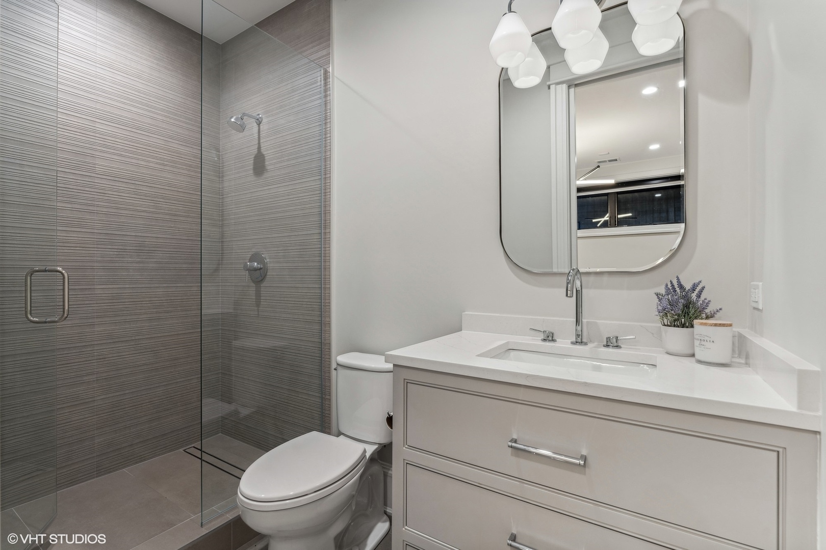 2034 North Mohawk Street, Unit 1 Chicago, IL 60614 - Photo 22 of 26 a bathroom with a sink a toilet and shower