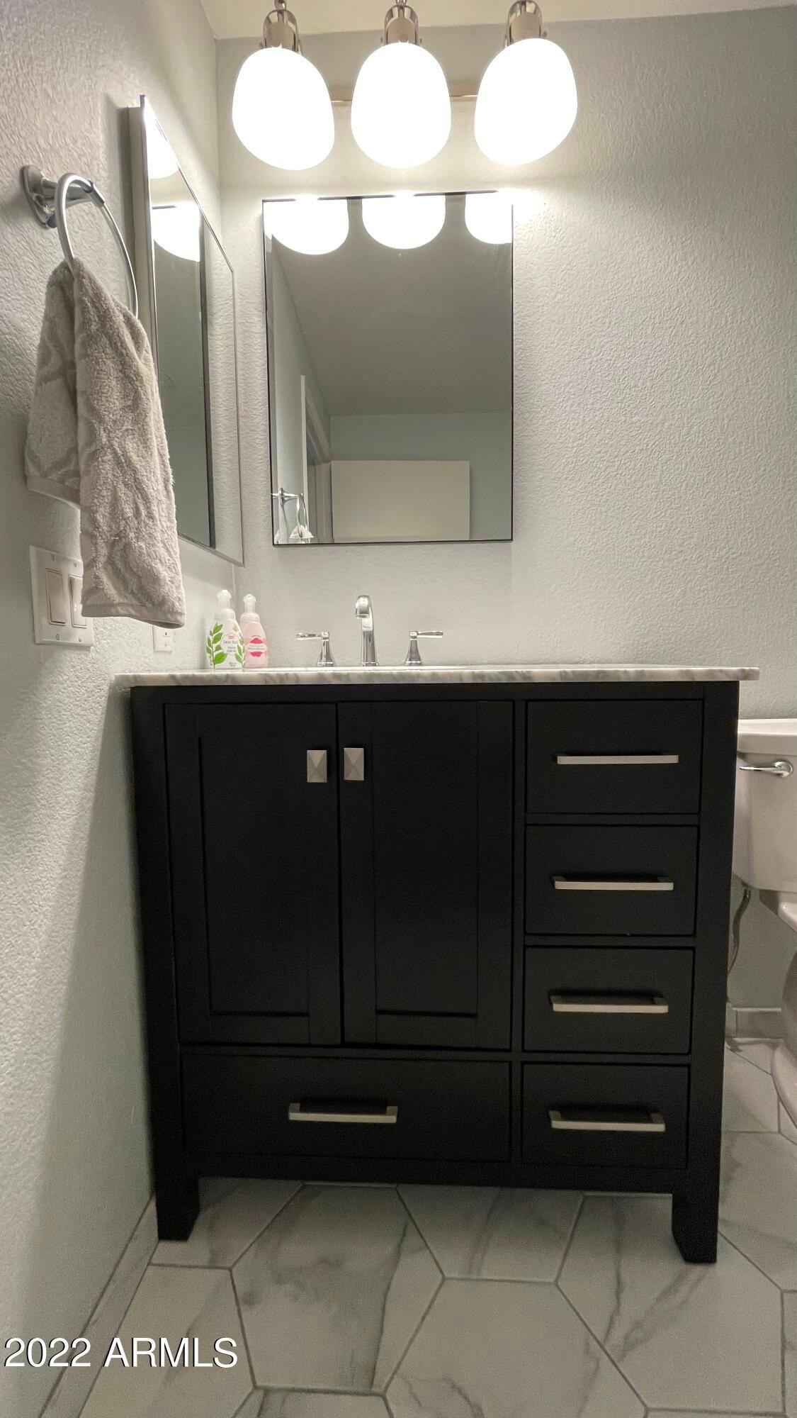 3302 North 7th Street, Unit 222 Phoenix, AZ 85014 - Photo 18 of 30 a bathroom with a sink vanity and mirror