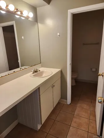 a bathroom with a sink vanity and a mirror