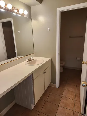 a bathroom with a sink vanity and a mirror