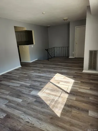 a view of staircase with wooden floor and chair