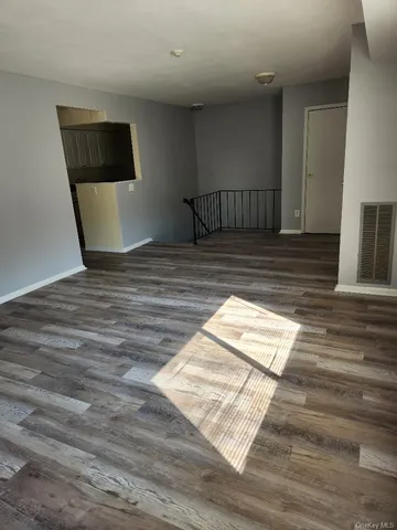 a view of staircase with wooden floor and chair