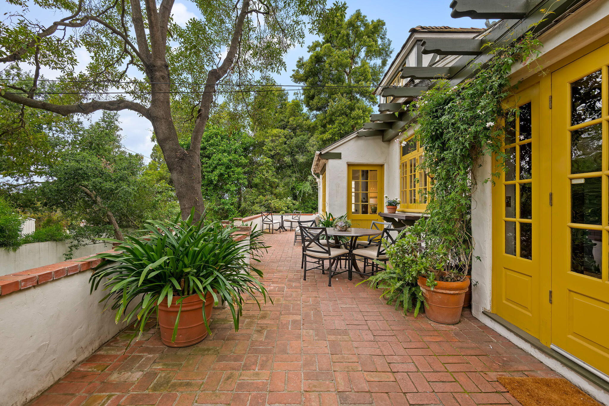 2040 Mission Ridge Road Santa Barbara, CA 93103 - Photo 18 of 38 a view of a patio with table and chairs and potted plants