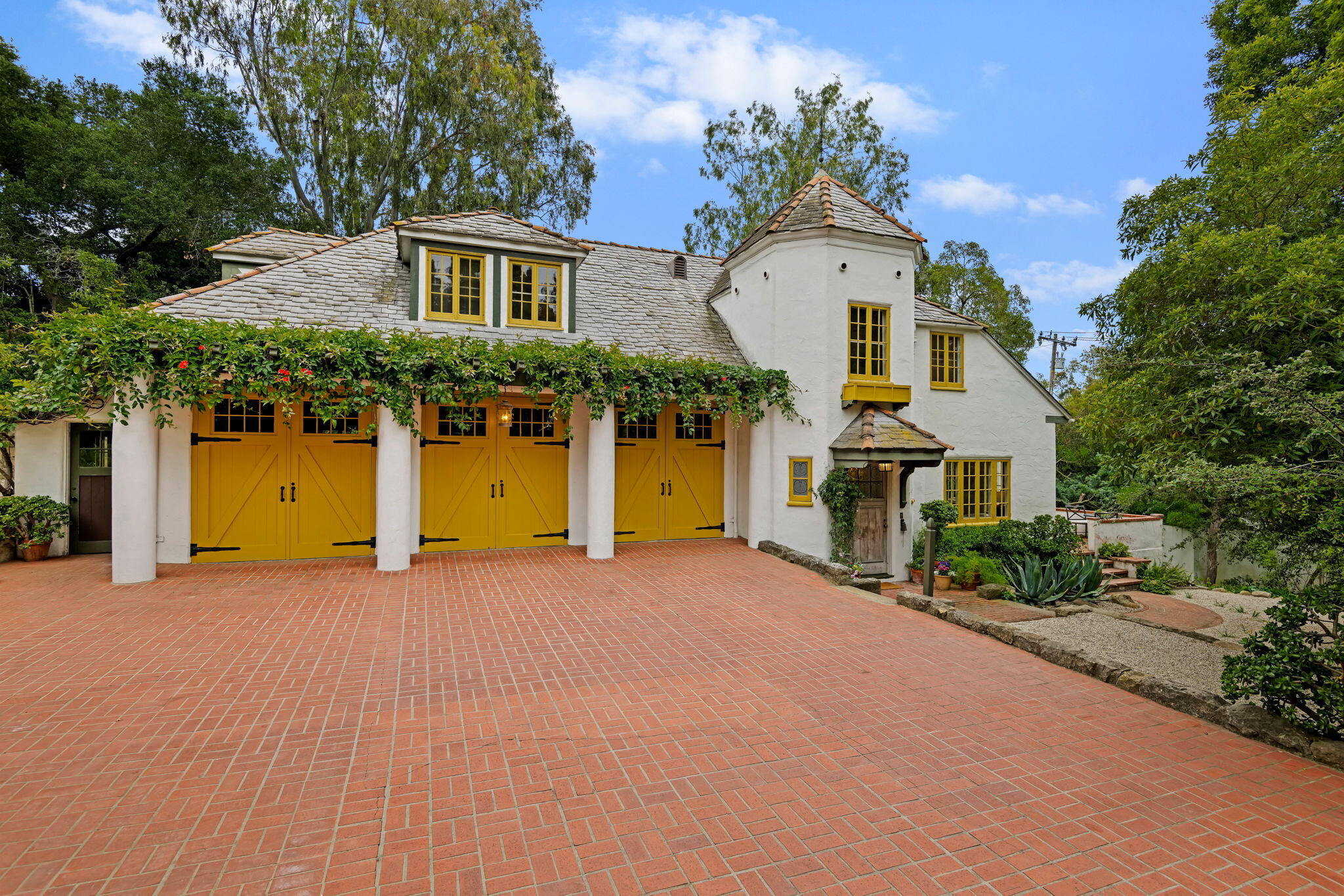 2040 Mission Ridge Road Santa Barbara, CA 93103 - Photo 2 of 38 a front view of a house with a yard and garage