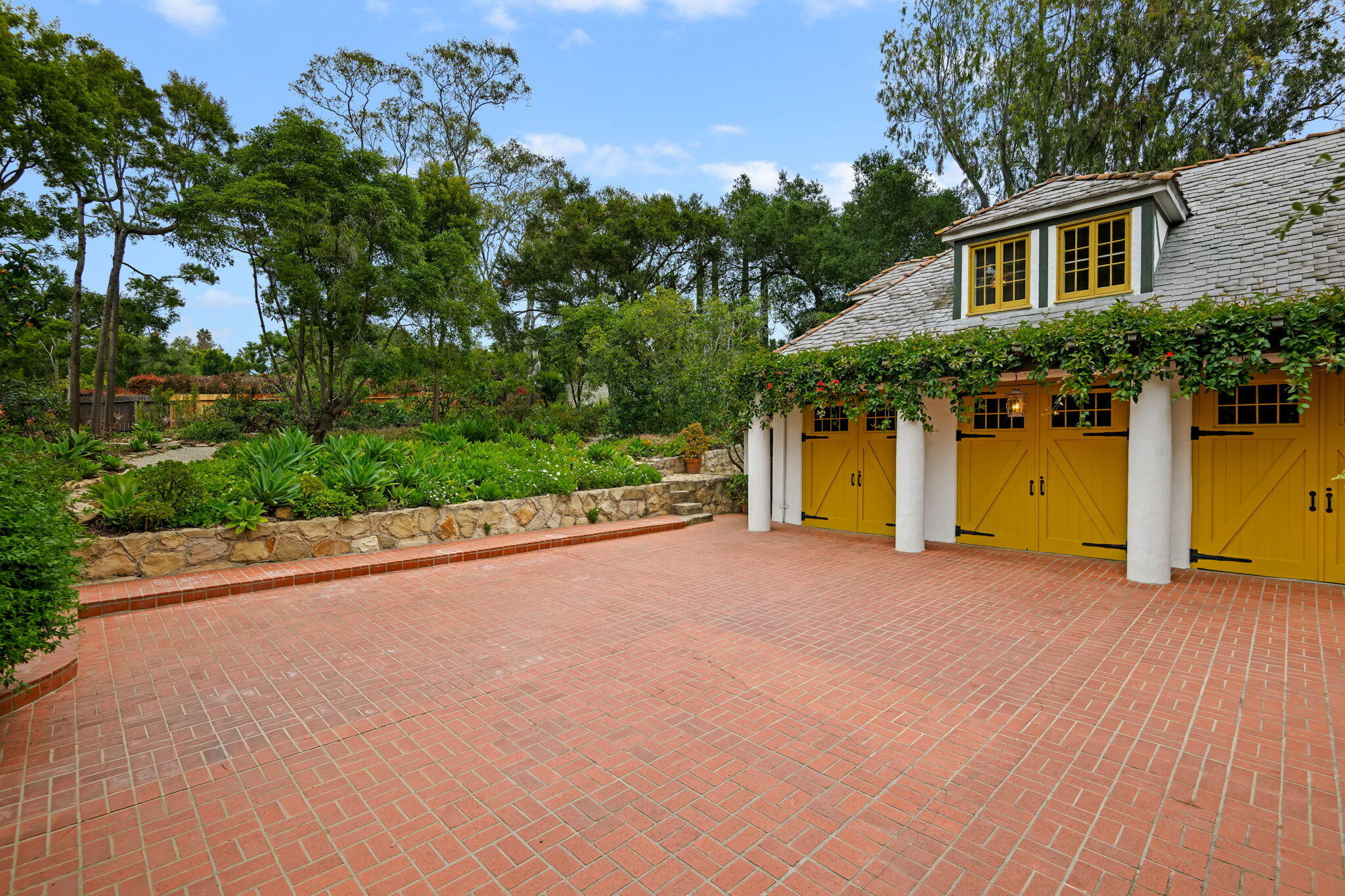 2040 Mission Ridge Road Santa Barbara, CA 93103 - Photo 3 of 38 a view of a house with a yard and garage