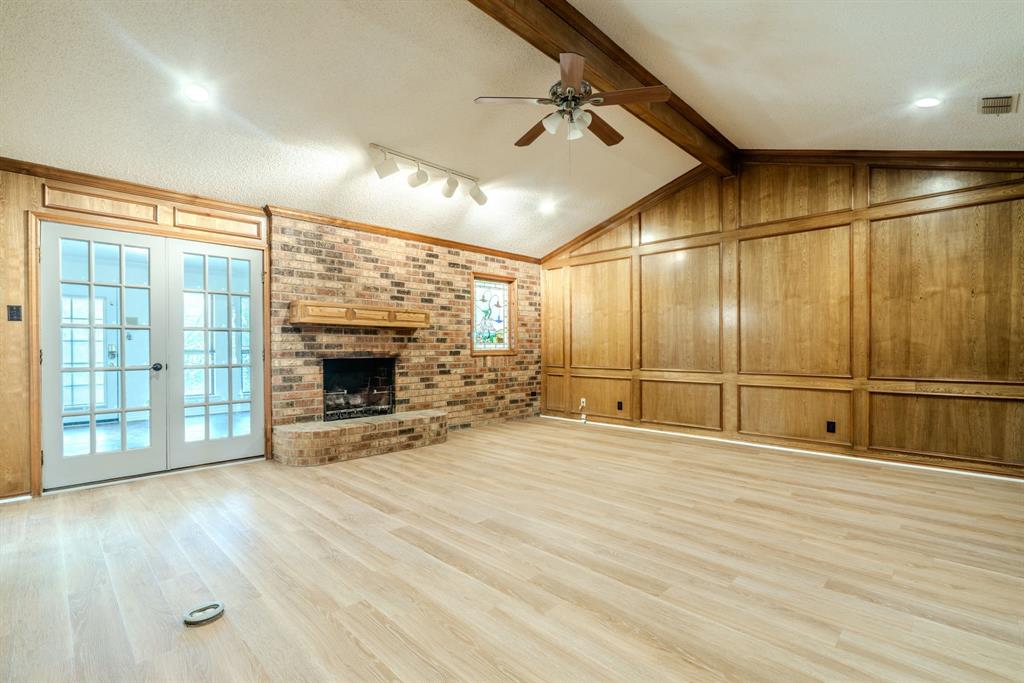 4501 Ridge North Road Fort Worth, TX 76126 - Photo 7 of 39 Fireplace and french doors to sunroom