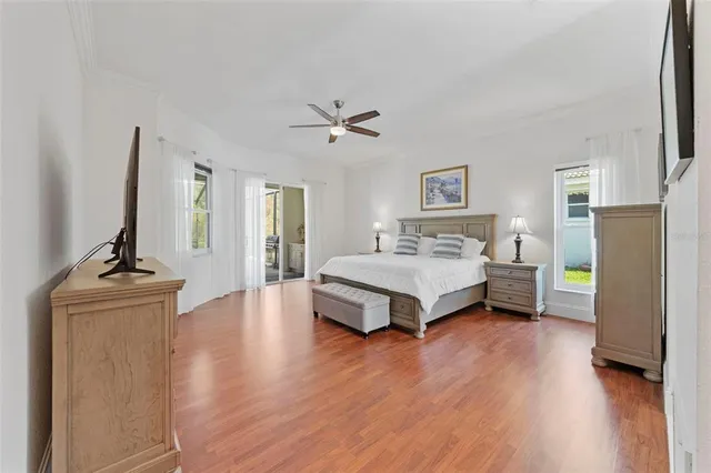 a bedroom with a bed and a chandelier