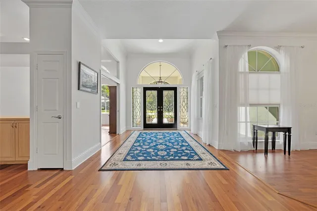 a living room with a rug and a table