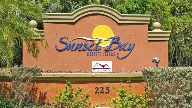 a view of swimming pool with a outdoor seating and a signage