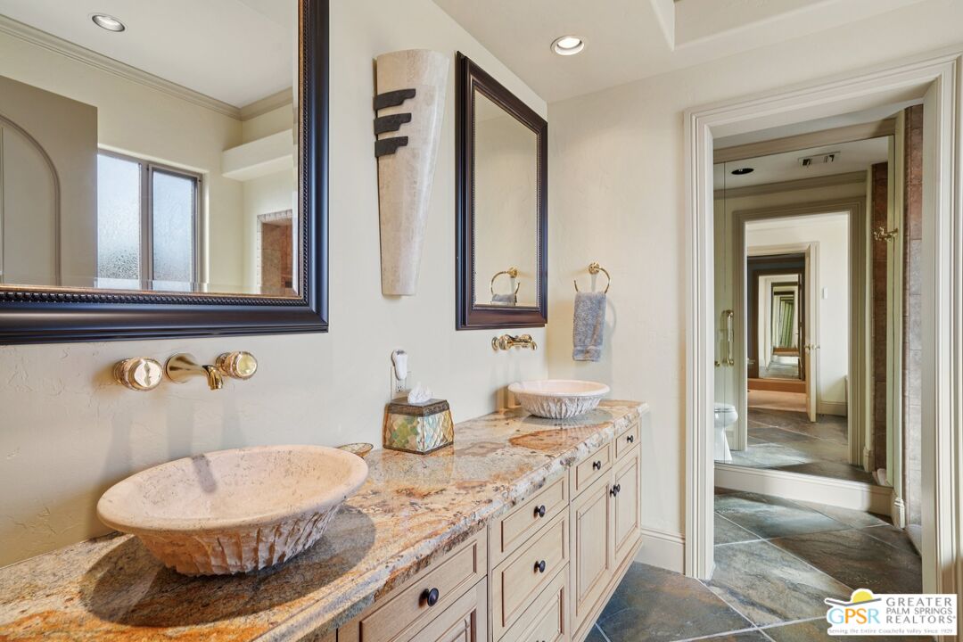 20 Clancy Lane Estates Rancho Mirage, CA 92270 - Photo 30 of 75 a bathroom with a granite countertop sink and a mirror