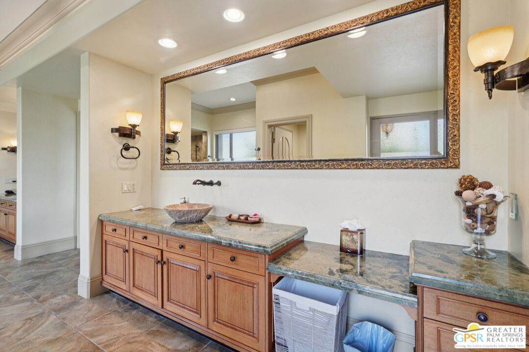20 Clancy Lane Estates Rancho Mirage, CA 92270 - Photo 53 of 75 a bathroom with a granite countertop sink a mirror and shower