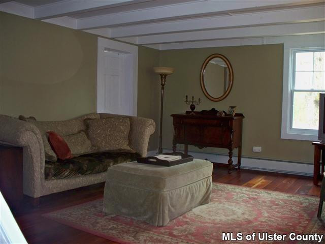 528 Peak Road Stone Ridge, NY 12484 - Photo 2 of 17 a living room with furniture a window and a fireplace