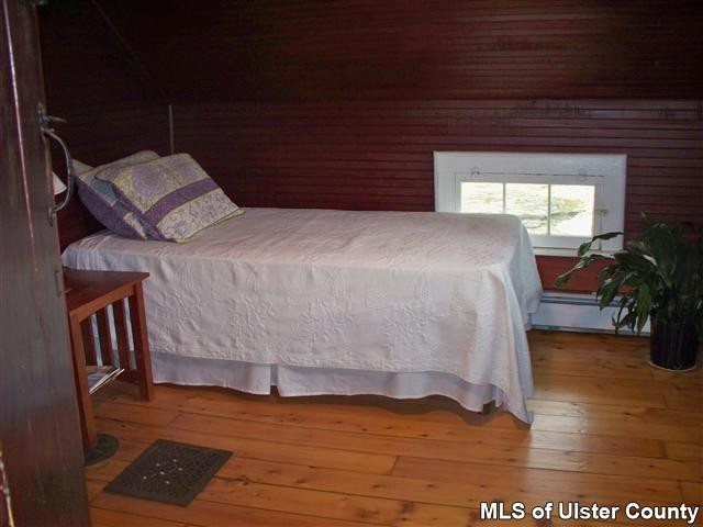 528 Peak Road Stone Ridge, NY 12484 - Photo 6 of 17 a bed sitting in a bedroom next to a window