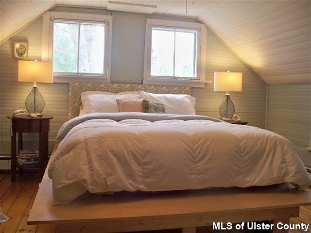 528 Peak Road Stone Ridge, NY 12484 - Photo 7 of 17 a bedroom with a bed and wooden floor