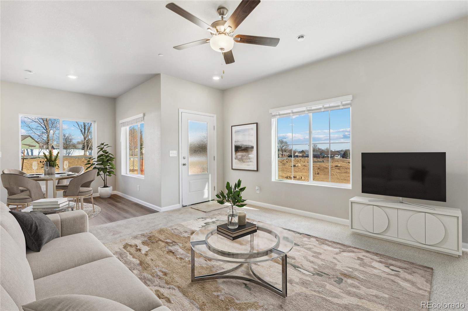 187 Robin Road Johnstown, CO 80534 - Photo 2 of 16 a living room with furniture and a flat screen tv