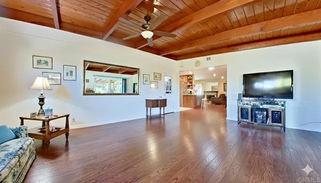 a view of a livingroom with furniture and a flat screen tv