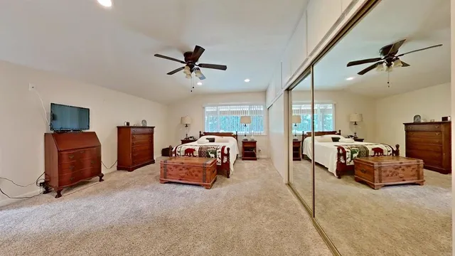 a living room with furniture gym equipment and a ceiling fan