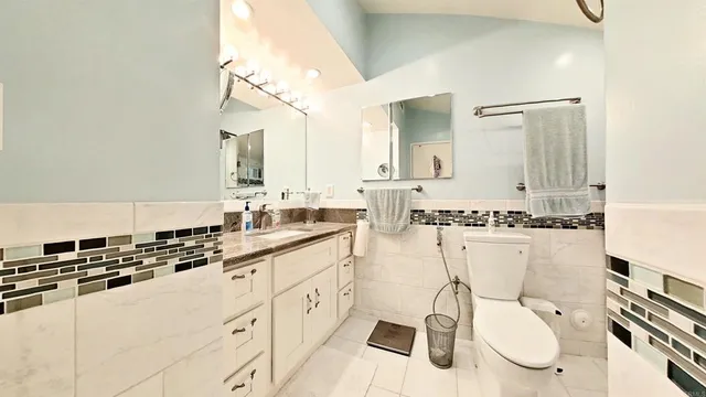 a bathroom with a granite countertop sink mirror and