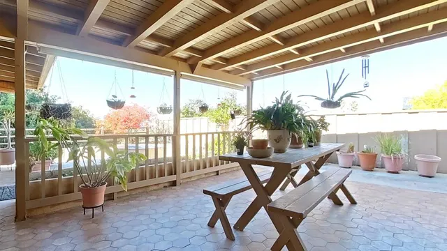a building outdoor space with patio furniture and potted plants