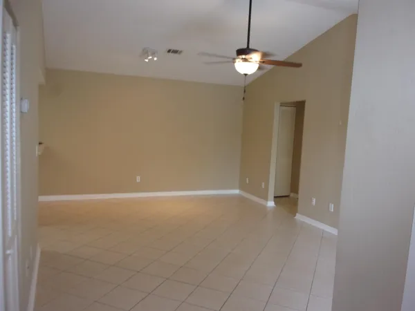 an empty room with windows and chandelier