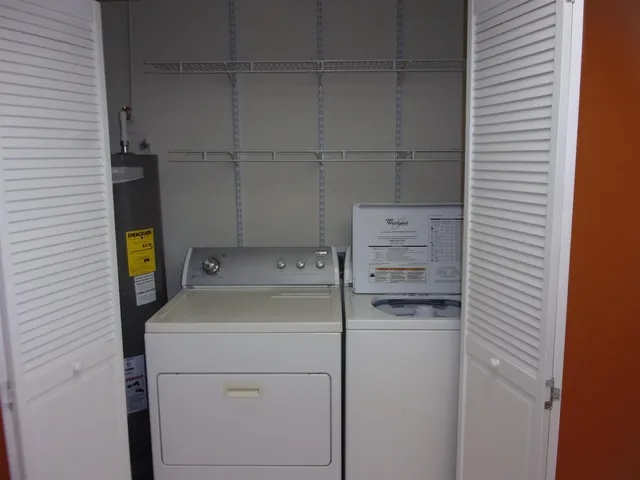 a kitchen with a stove top oven and cabinets