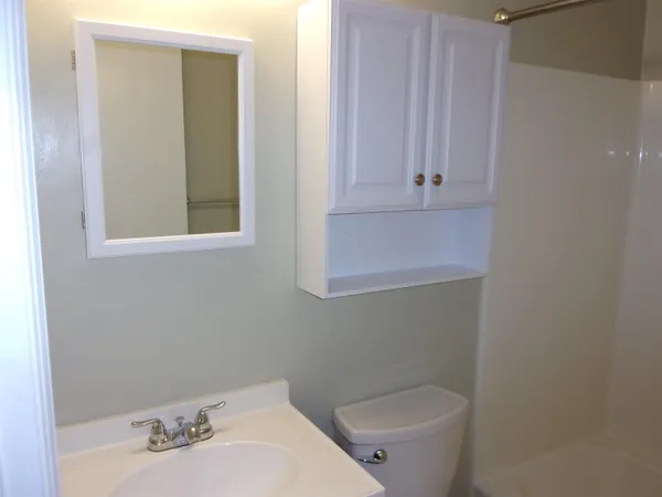 an empty room with a mirror and door