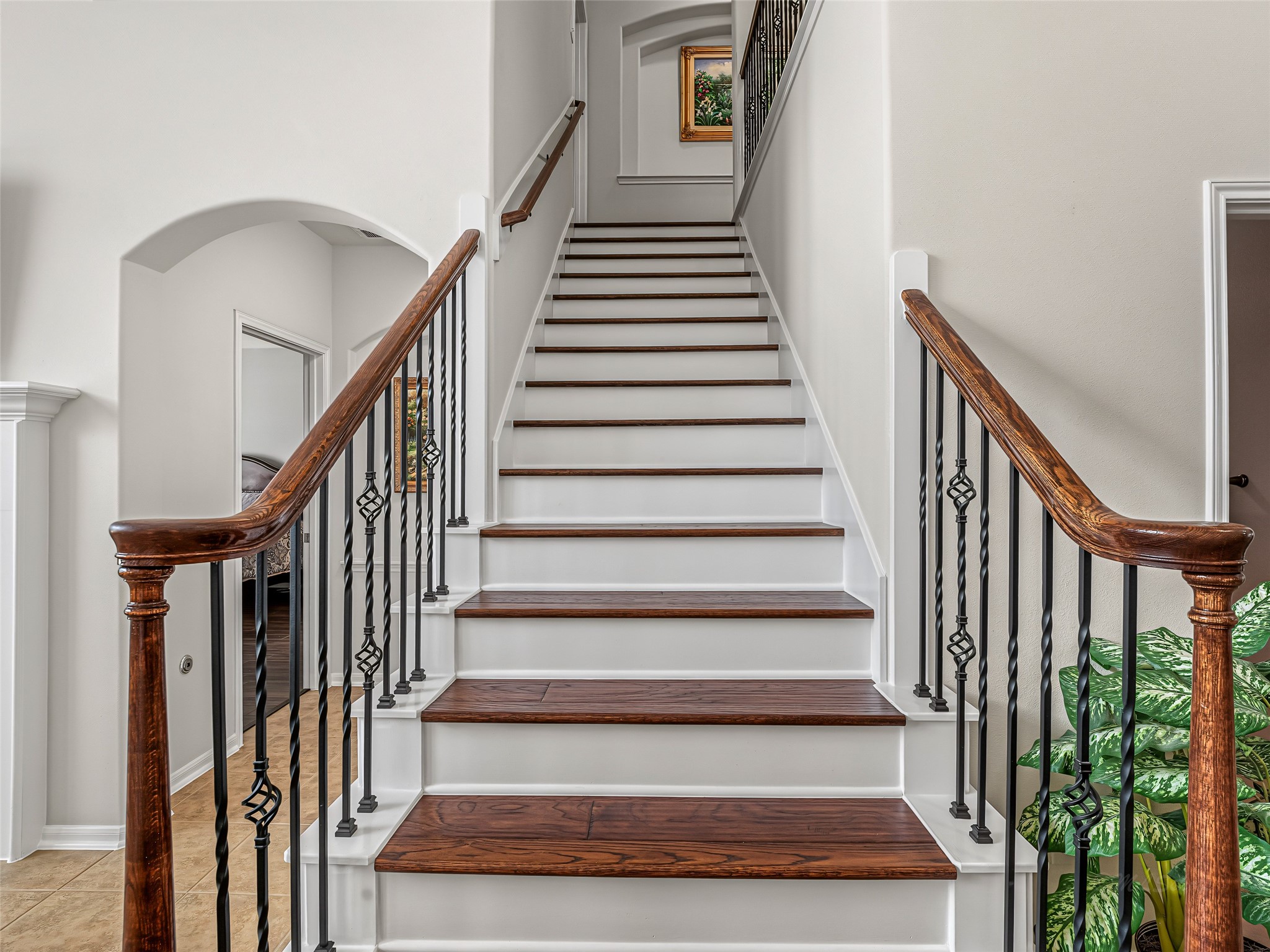 2210 Fox Path Katy, TX 77494 - Photo 30 of 47 This beautifully crafted central staircase makes a striking architectural statement, serving as a smooth transition between the home's primary living areas and the upper level.