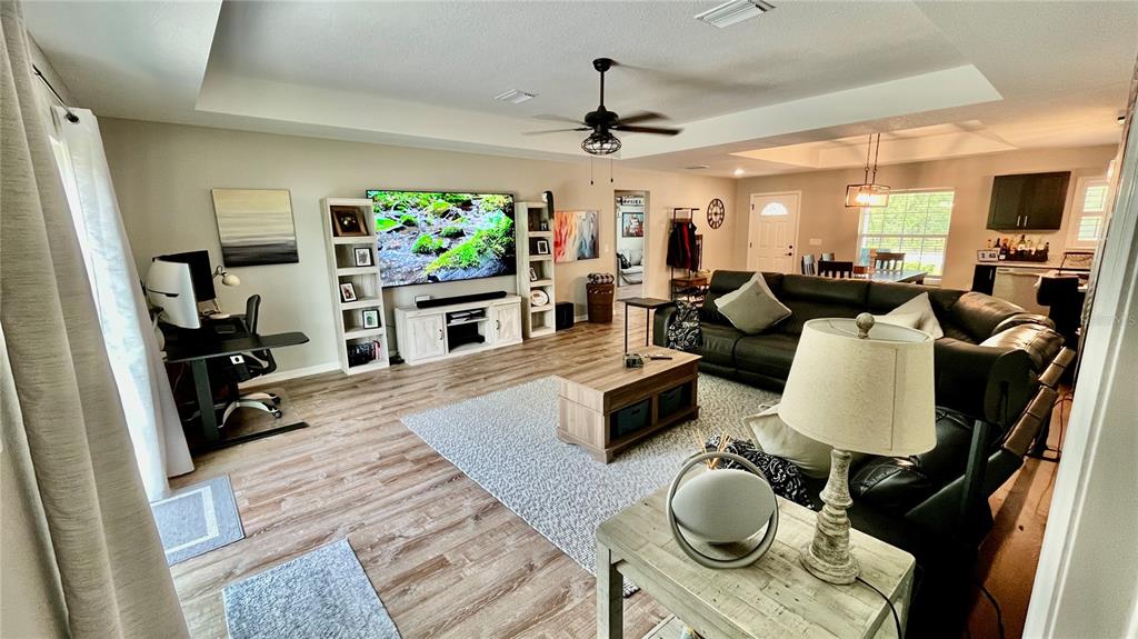 13486 English Sparrow Road Weeki Wachee, FL 34614 - Photo 21 of 51 a living room with furniture and a flat screen tv