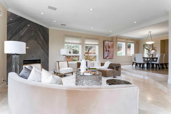 a living room with fireplace furniture and a table