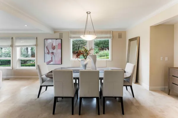 a dining room with furniture a chandelier and window