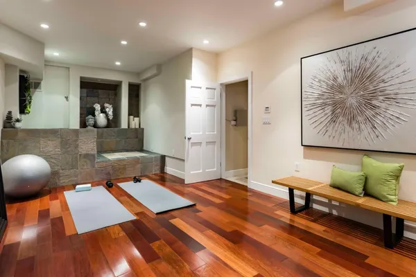 a living room with furniture and a wooden floor