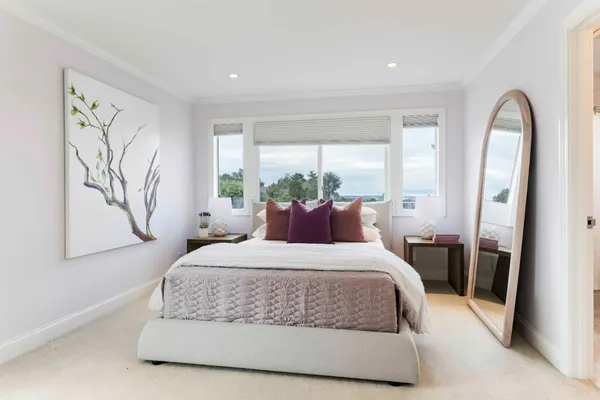 a bedroom with a large bed and a window