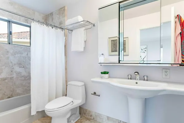a bathroom with a sink toilet and shower