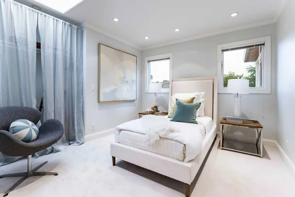a bedroom with a bed and chair