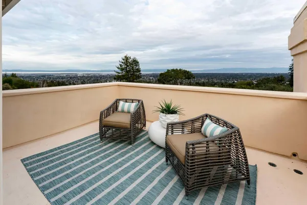 a balcony with wooden floor and city view