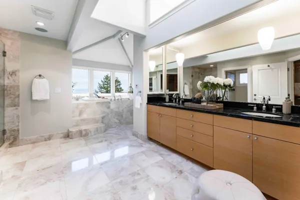 a spacious bathroom with a toilet sink and mirror