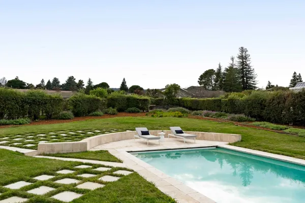 a view of a swimming pool with a yard