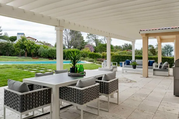 a view of swimming pool with outdoor seating and plants