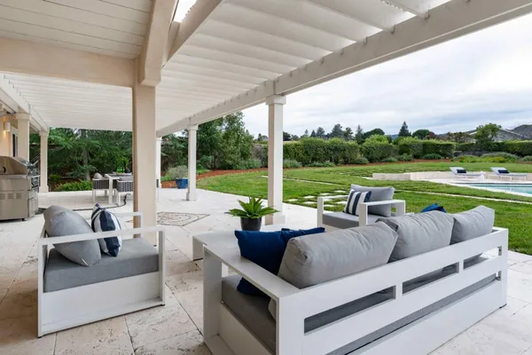 a balcony with table and chairs