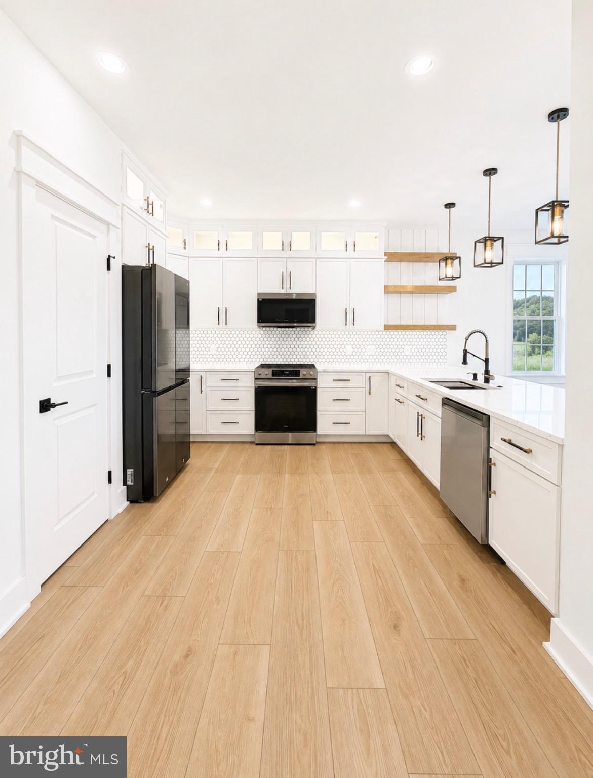 21963 Hardscrabble Road Georgetown, DE 19947 - Photo 4 of 43 Sleek modern kitchen with bright finishes.