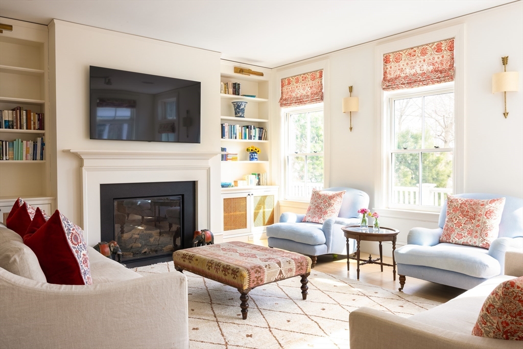 371 Walnut Street Brookline, MA 02445 - Photo 12 of 40 a living room with furniture a flat screen tv and a fireplace