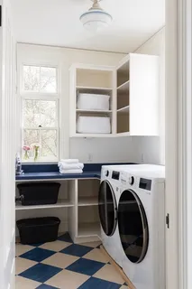 a utility room with cabinets dryer and washer