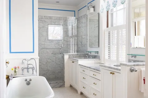 a bathroom with a sink double vanity and a mirror