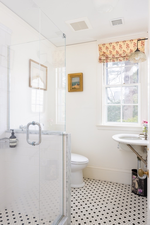 371 Walnut Street Brookline, MA 02445 - Photo 22 of 40 a bathroom with a sink a toilet and a window