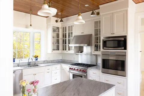 a kitchen with stainless steel appliances a stove a sink and a refrigerator