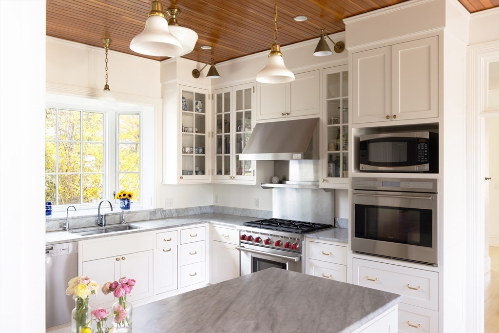 371 Walnut Street Brookline, MA 02445 - Photo 8 of 40 a kitchen with stainless steel appliances a stove a sink and a refrigerator