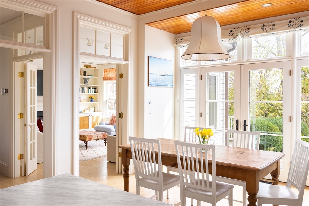 371 Walnut Street Brookline, MA 02445 - Photo 10 of 40 a view of a dining room with furniture a chandelier and wooden floor