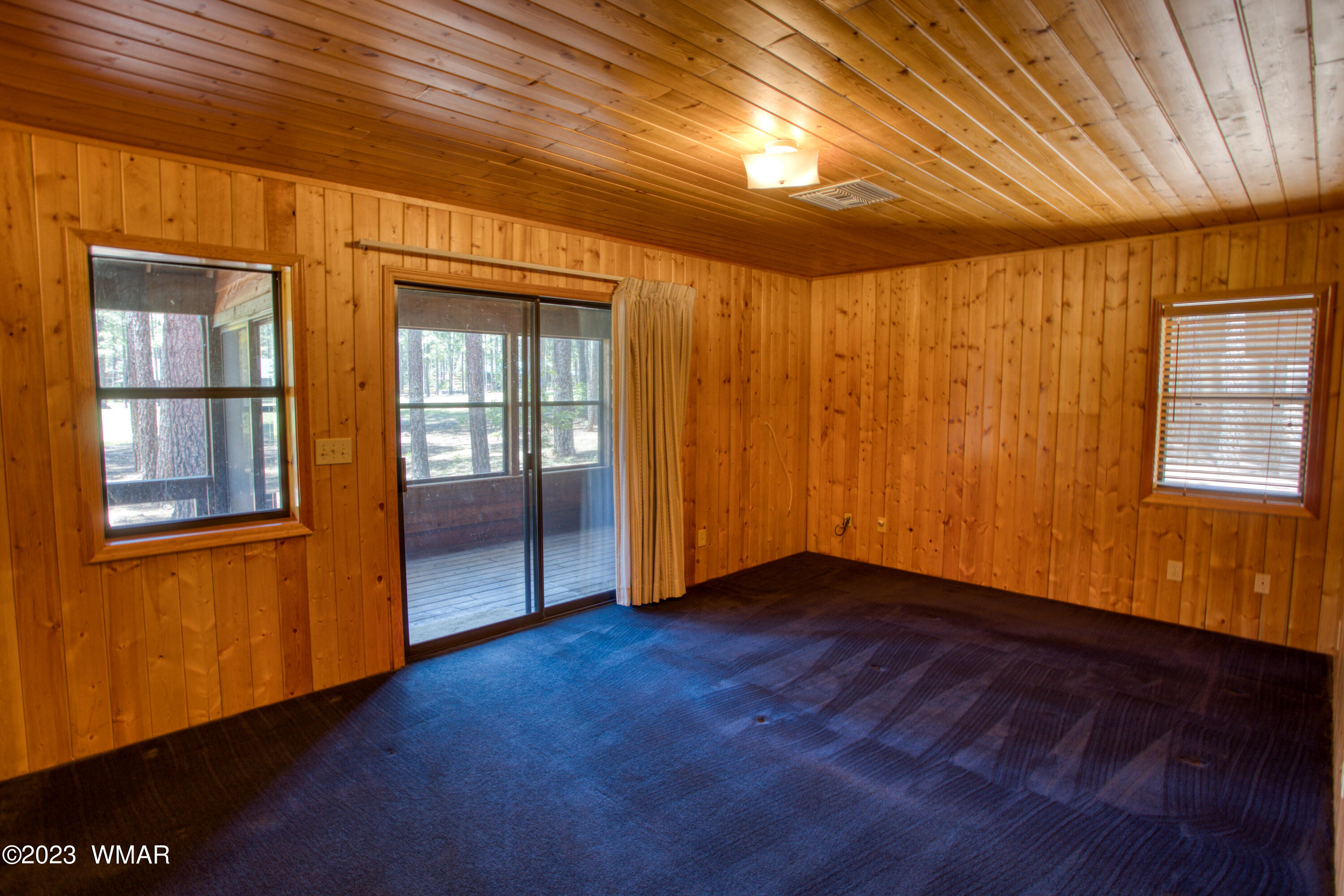 3288 Lake View Drive Pinetop, AZ 85935 - Photo 11 of 32 an empty room with wooden floor and windows